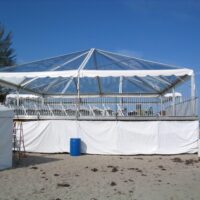 Custom built elevated decking with a 40' x 40' clear tent on top.