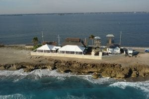 Wedding at the House of Refuge featuring 30' wide frame tents with clear sides.