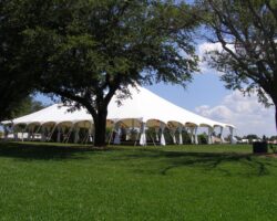 Wedding at a country club featuring a 60' x 90' pole tent with leg drapes and Chinese paper lanterns.