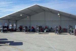 20m x 10m structure tent with an open end used for a temporary race garage.