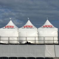 Three 10' x 10' hi-peak tents with white sidewalls and customer logos.