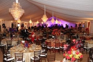 Black tie fundraiser held in a 20m structure tent with tent liner, wall drape, 12 chandeliers, and mahogany chiavari chairs.