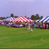 20' x 20' frame tents in blue and white and red and white stripes.