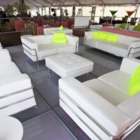Frosted acrylic staging with white leather furniture.