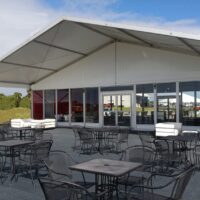 15m x 15m tent with porch and glass walls.