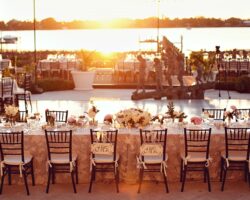 Wedding on the river in Vero Beach featuring a pool cover and mahogany chiavari chairs.