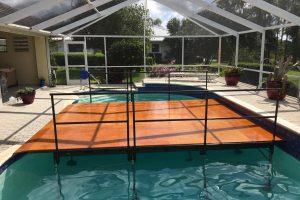 14' x 20' partial pool cover with a wood deck and safety railing at a private residence used for a wedding ceremony.